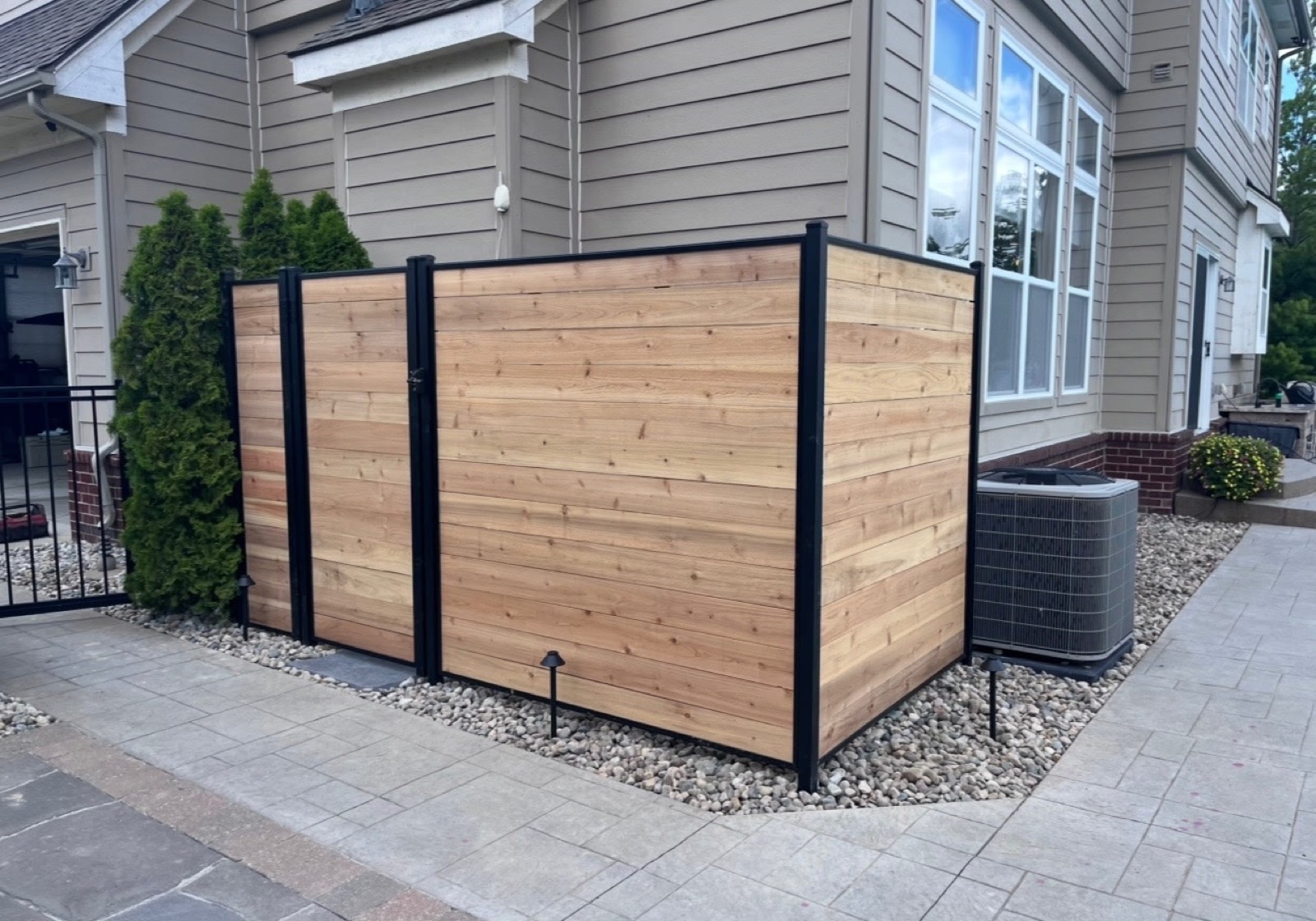 Aluminum posts with wood-look vinyl inserts on a Northern Indiana fence project